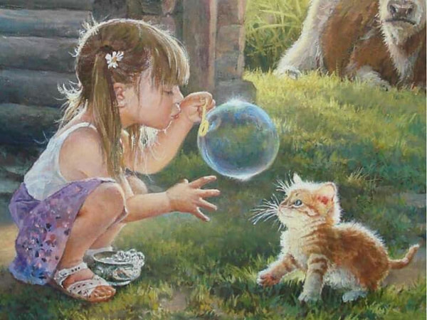 Девочка и котенок играют с мыльными пузырями